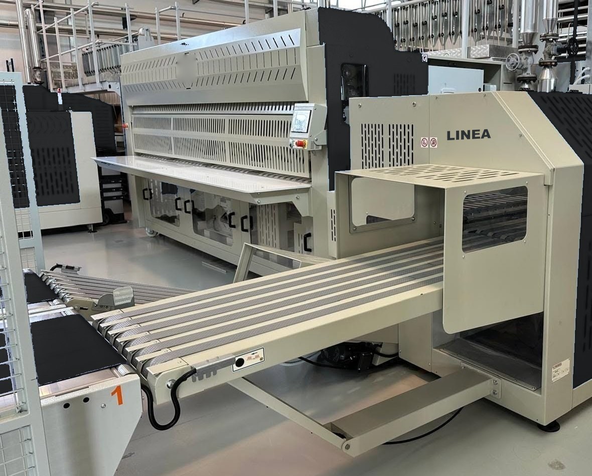 Folding and stacking machine installed in a working laundry
