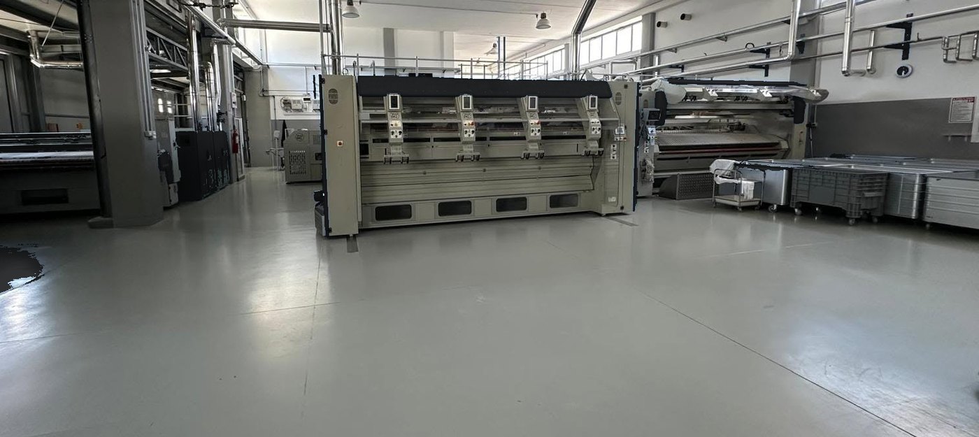 Feeding stations and flatwork ironer installed and running in a laundry