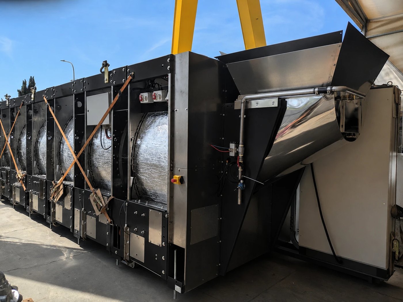 POSEIDON continuous tunnel washer lifted by gantry crane during build